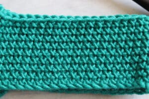 green fabric close up cross stitch