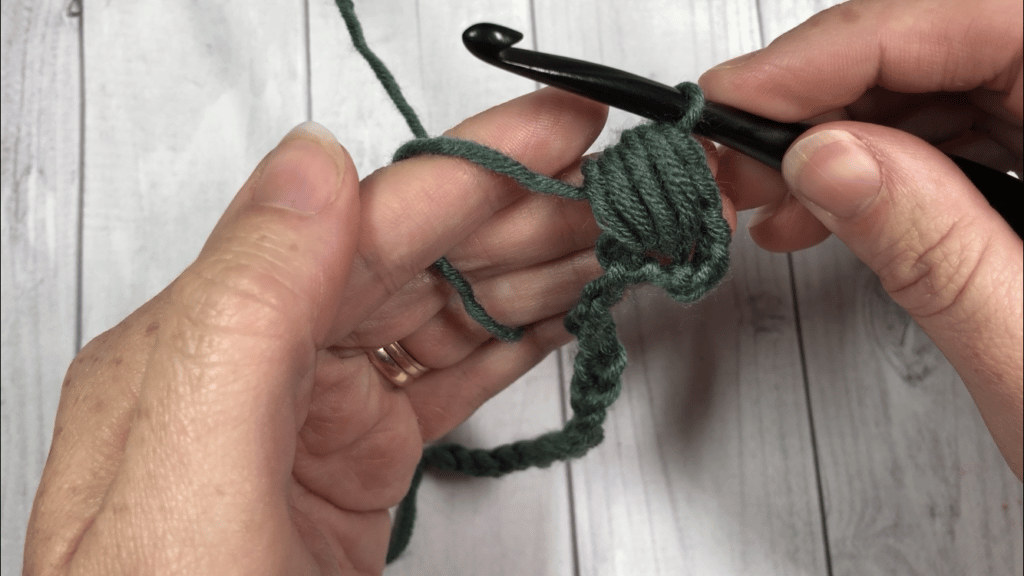 Demonstration of how a crochet puff stitch is made