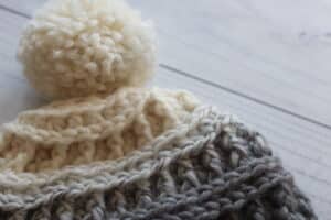 close up of crochet hat top with pompom