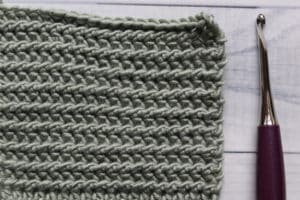 half double slip stitch swatch in green, purple crochet hook