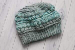 teal coloured crochet hat with puff stitches