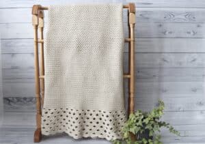 white crochet blanket with lace edging