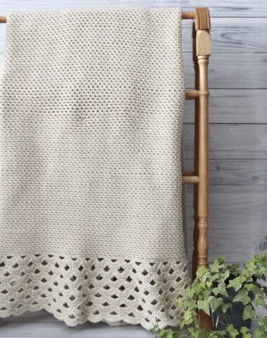 white crochet blanket with lace edging