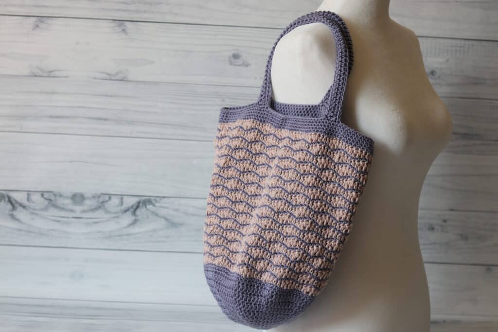 crochet market bag in pink and purple featuring the wave stitch