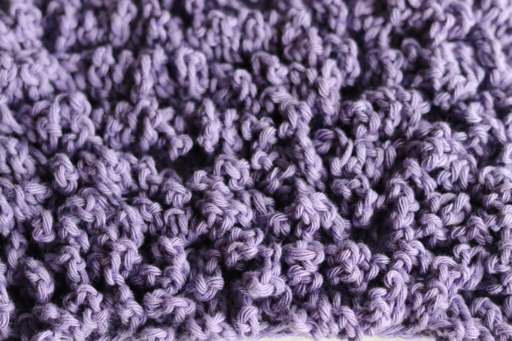 close up on the chain loop crochet stitch in purple yarn