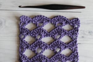 the open shell crochet stitch worked in purple yarn
