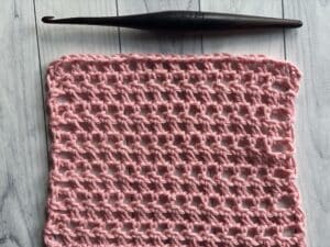 half double crochet mesh stitch shown in pink yarn