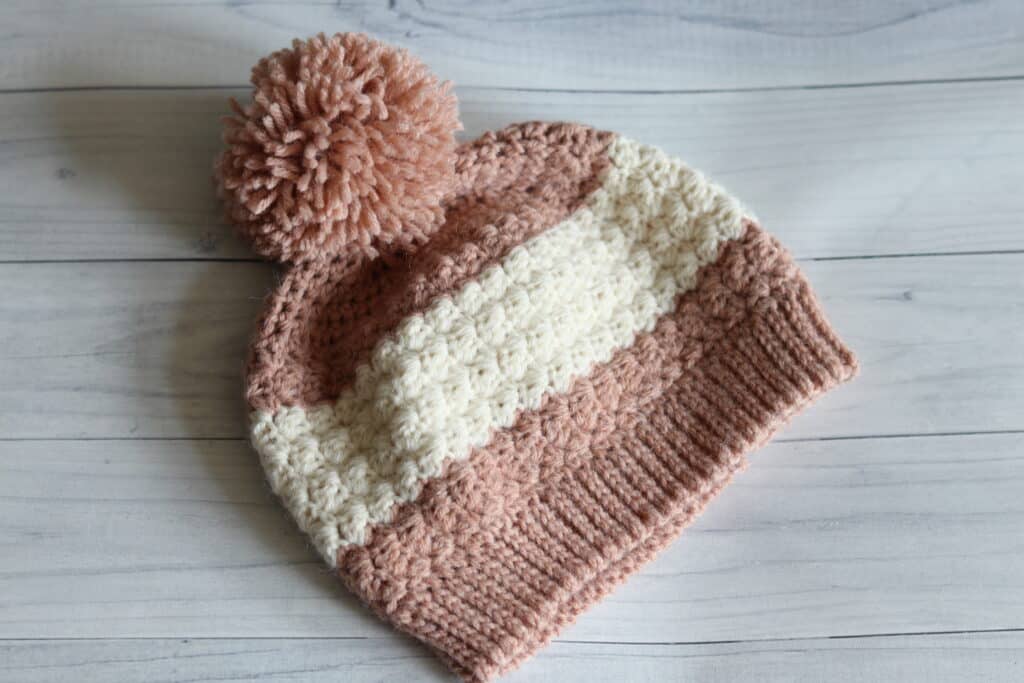 pink crochet hat with a white stripe
