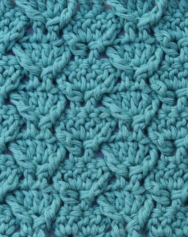 a close up of the dove tail crochet stitch worked in green yarn
