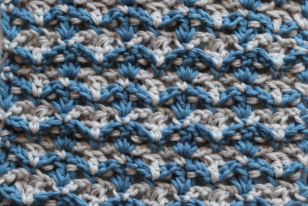 the crochet fleur de lys stitch in blue and white