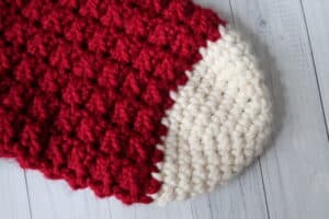 close up of the toe of a red and white crochet Christmas stocking