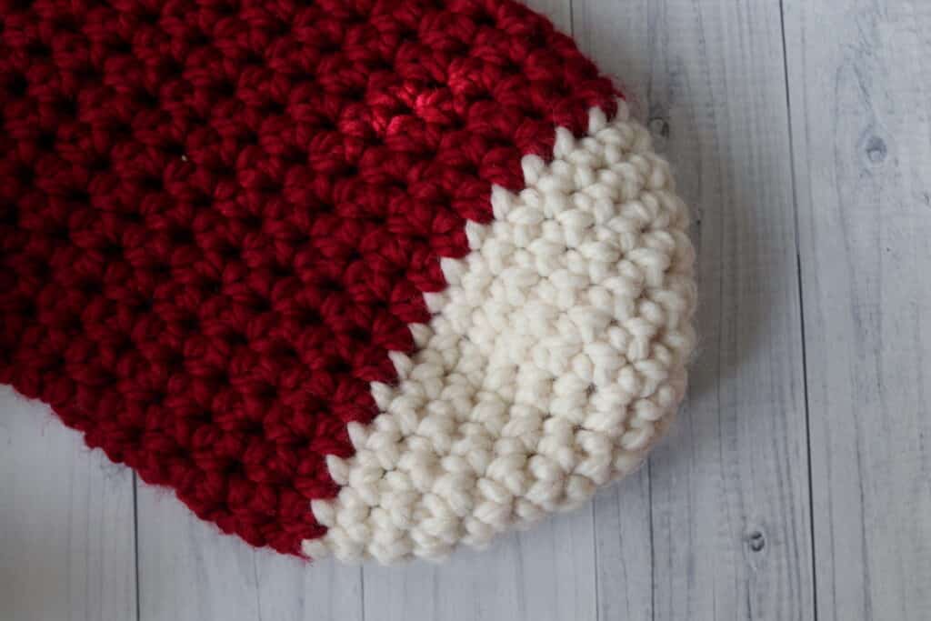 close up of the toe on a red and white crochet Christmas stocking