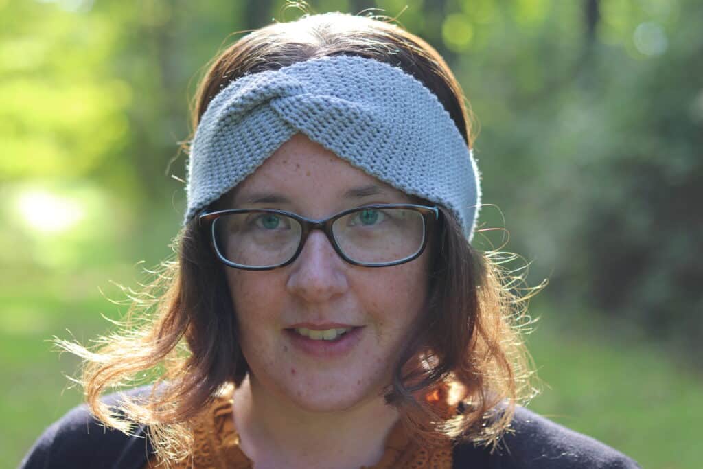 woman wearing a crochet twisted ear warmer