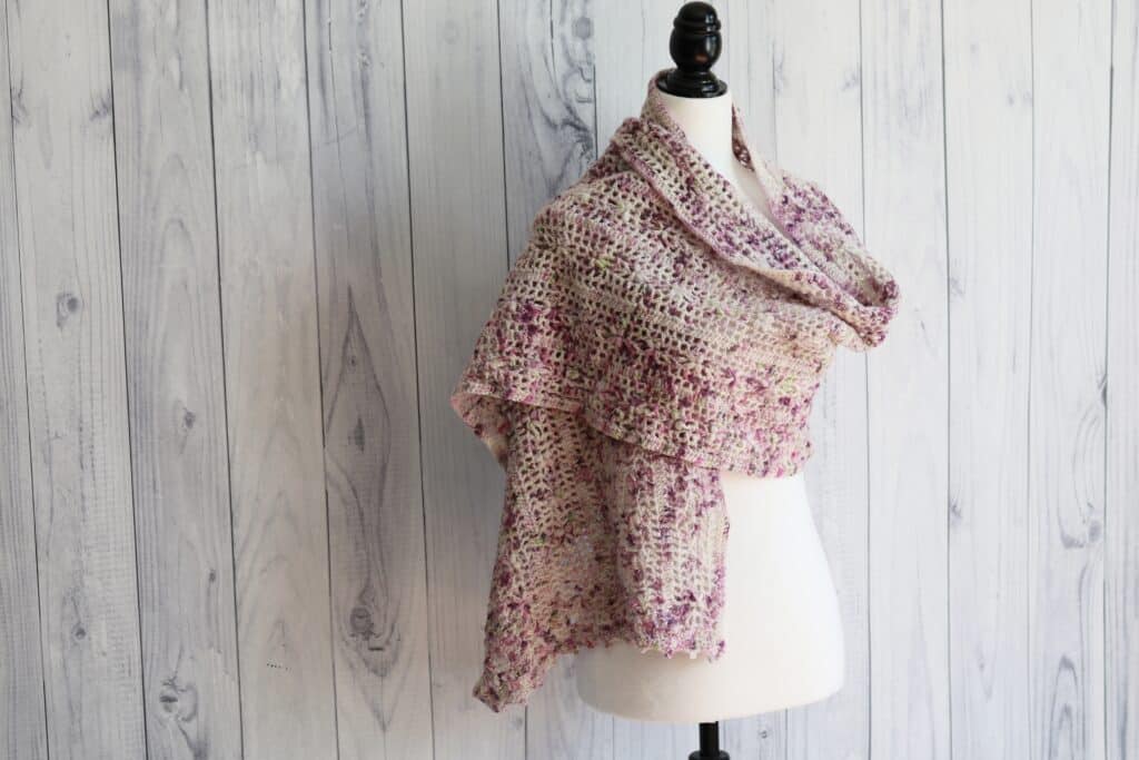 pink and white crochet lace shawl with small flowers