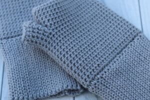 close up of grey crochet fingerless gloves