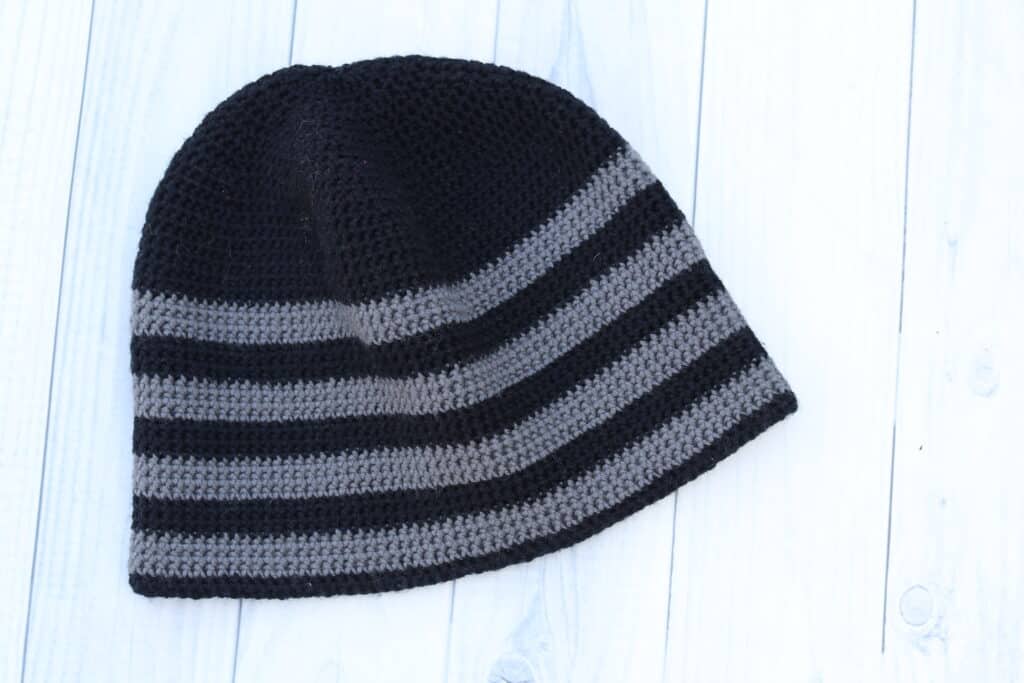 close up of the brim of a grey and white striped crochet hat