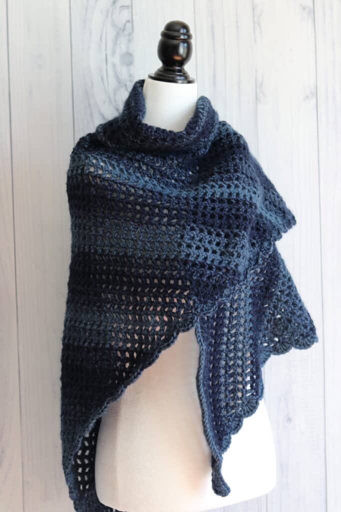 a navy blue crochet triangle shawl