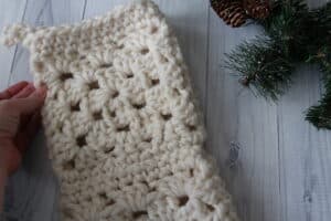 close up of the cuff of a white crochet christmas stocking