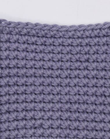 a swatch of the reverse single crochet spike stitch worked in purple yarn
