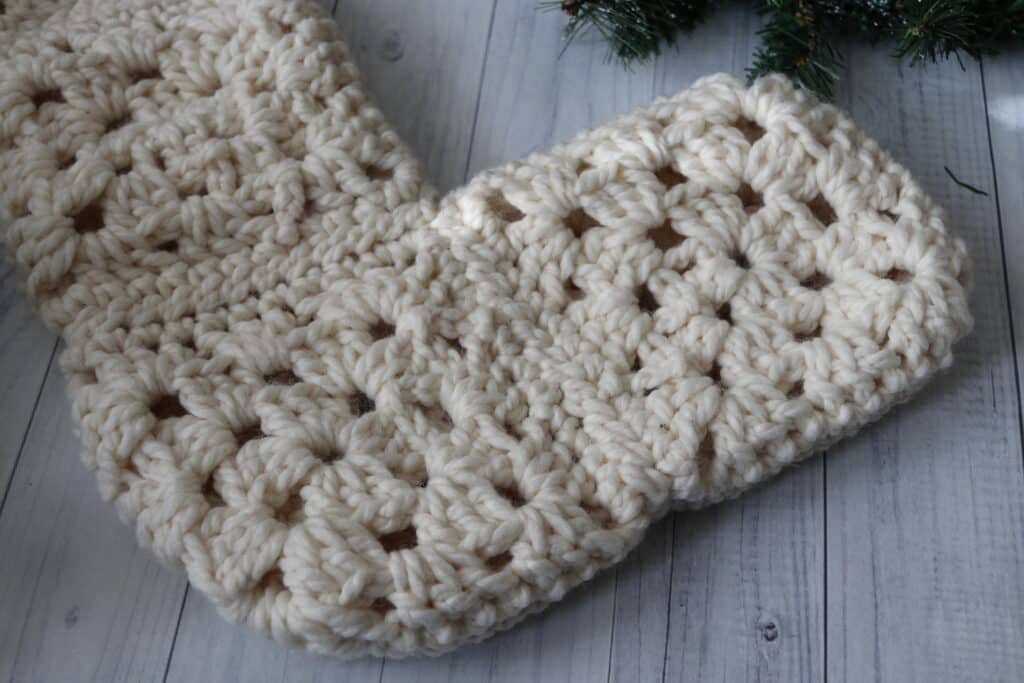 a close up of the foot of a crochet christmas stocking