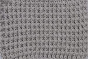 A swatch of the reverse half double crochet spike stitch in grey yarn