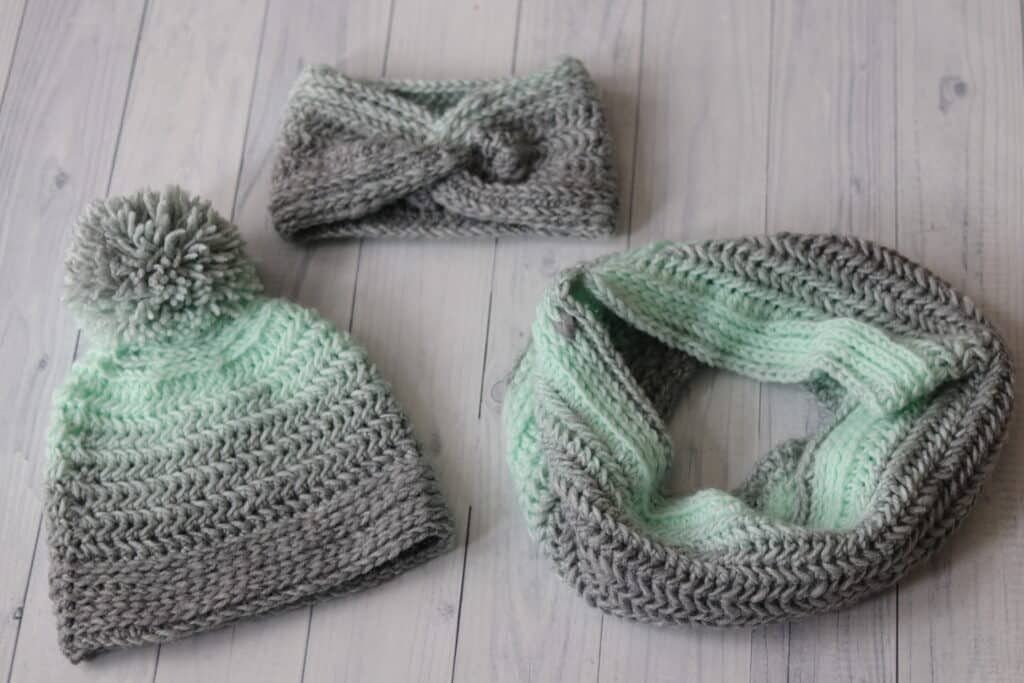 a crochet ear warmer, beanie and cowl in grey and mint coloured yarn