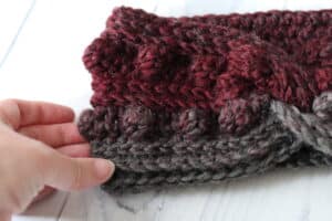 close up of the black cherry twisted crochet ear warmer
