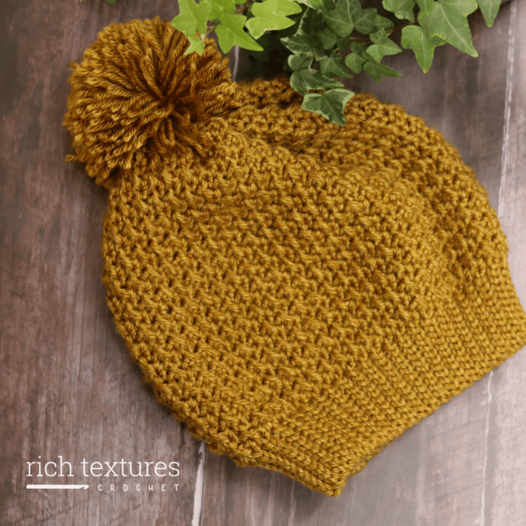 A textured crochet beanie worked in a golden coloured yarn