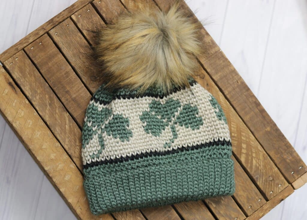 A crochet beanie featuring a shamrock design