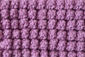 The Popcorn crochet stitch worked in pink yarn