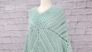 A Close up of the Wandering Poncho worked in aqua coloured yarn