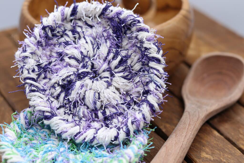 A purple and white crochet round scrubby