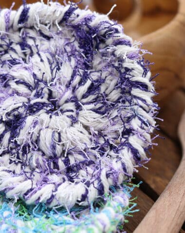 A purple and white crochet round scrubby