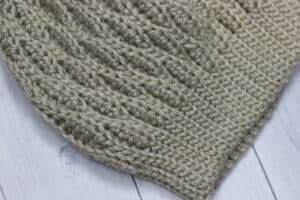 A close up of the crochet almond beanie brim