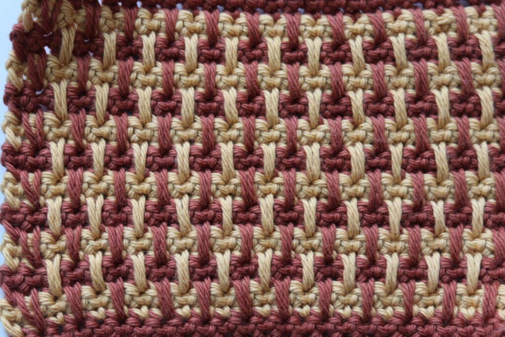 An easy crochet spike stitch worked in brown and gold yarn