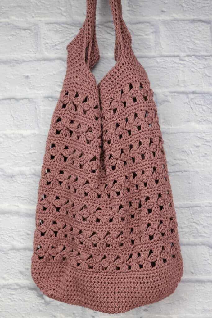 A Crochet Market bag worked in rose coloured yarn