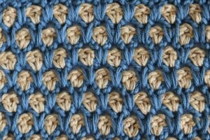 The Moroccan Tile Crochet Stitch worked in a gold and blue yarn