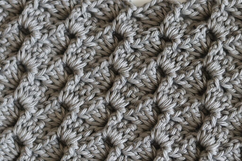 A Swatch of the crochet 3D shell stitch worked in grey yarn