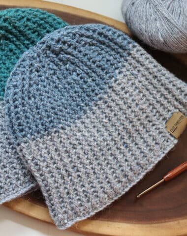Two Unisex crochet beanies worked in blue, green and grey yarn