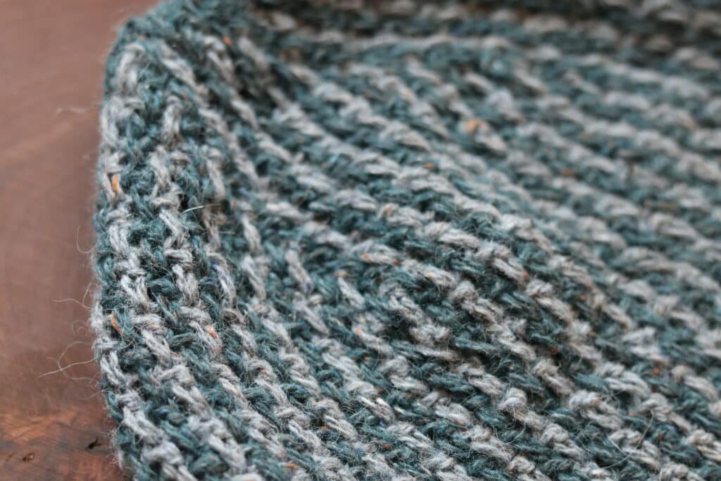 A Close up of the top of the crochet cabin beanie