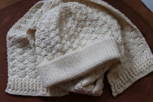 The Crochet Brighton Beanie and Scarf set worked in white yarn
