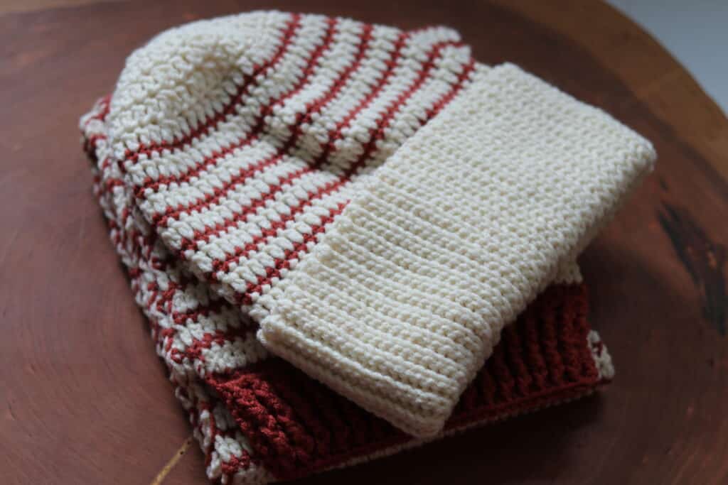 A copper and white crochet beanie and scarf set