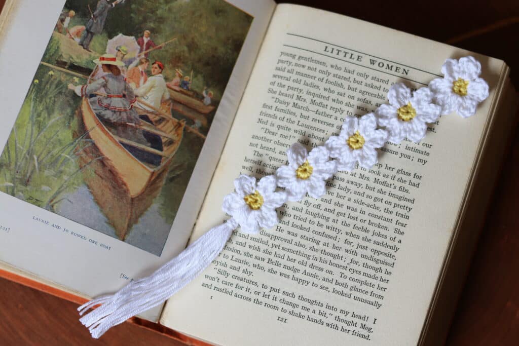 A Crochet Bookmark featuring 5 small white flowers with yellow centres