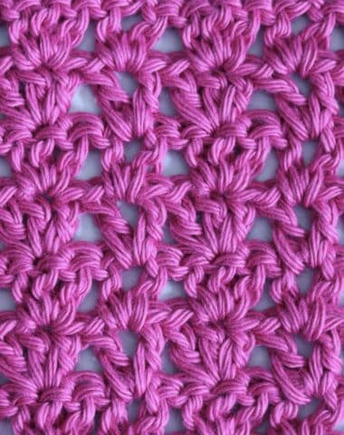A swatch of the V and Three crochet stitch pattern worked in a vibrant pink yarn