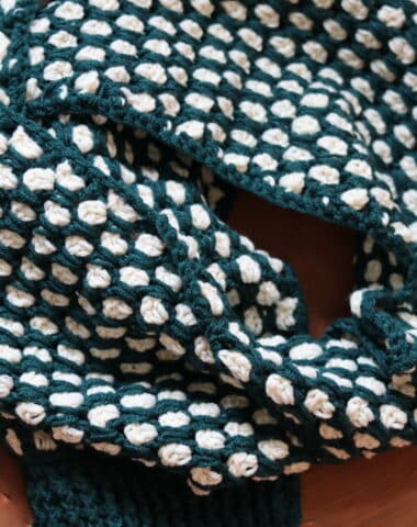 A Crochet scarf worked in the Moroccan Tile Stitch shown in green and white yarn