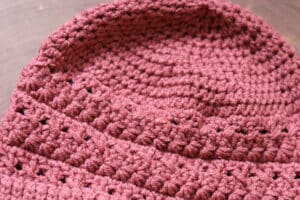 A Close up of the top of the crochet star-crossed beanie
