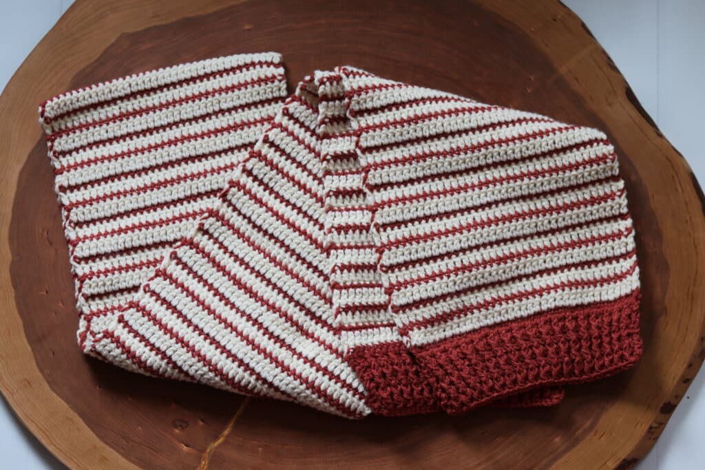 A brown and white striped crochet scarf