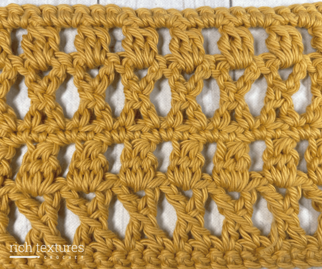 A lacy crochet stitch featuring crochet crosses and cluster stitches