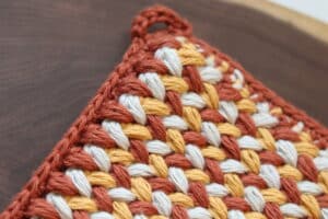 A close up of the loop hanger on the crochet Not So Vintage Hot Pad