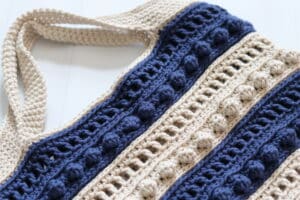 A close up of the handles on the Uptown Crochet Market Bag